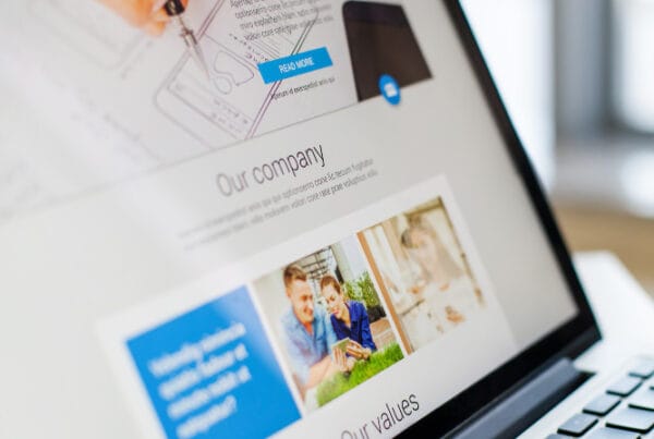 Asian Web Developers showcasing a modern business website on a laptop for a local Toronto small business owner.